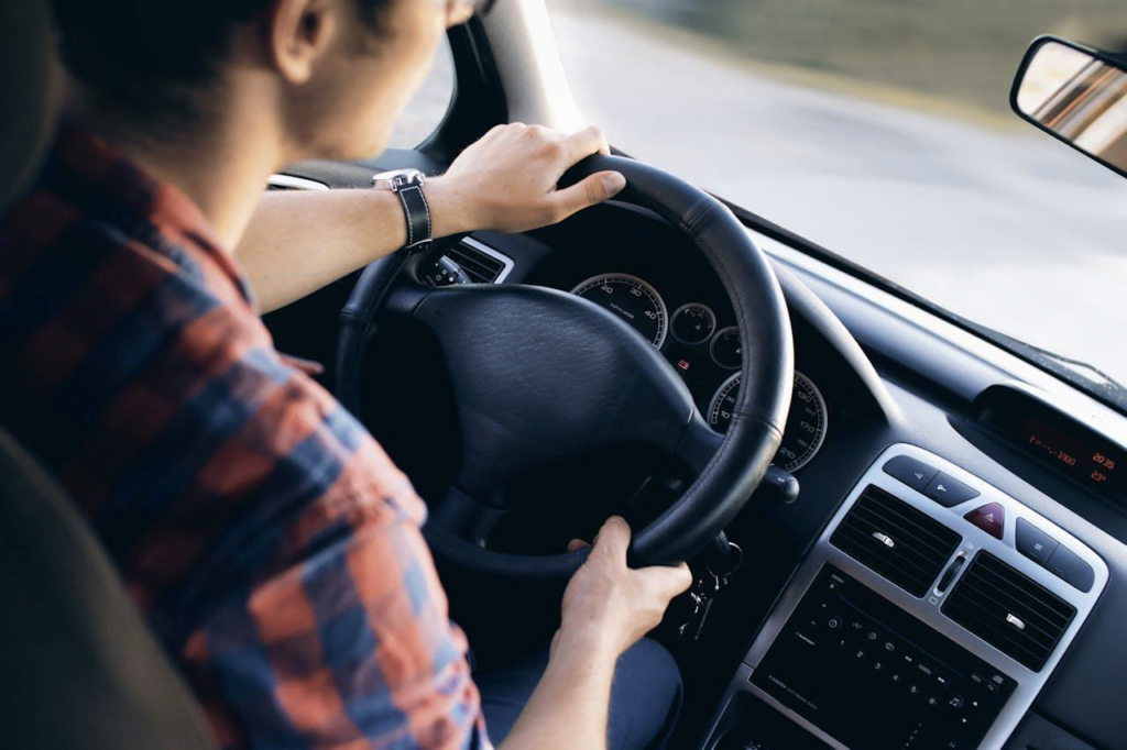 A man inside of a vehicle driving. 