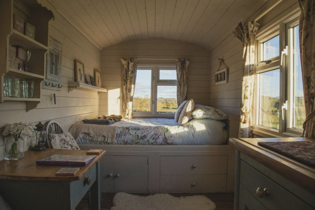 Bed with drawers underneath, placed beside windows. Bed Designs for Small Spaces.